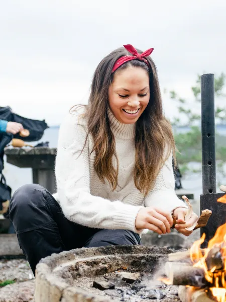 Tjej grillar vid öppen eld